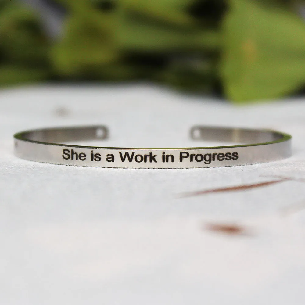 Silver customisable stainless steel bracelet with laser engraved text and adjustable fit on neutral background