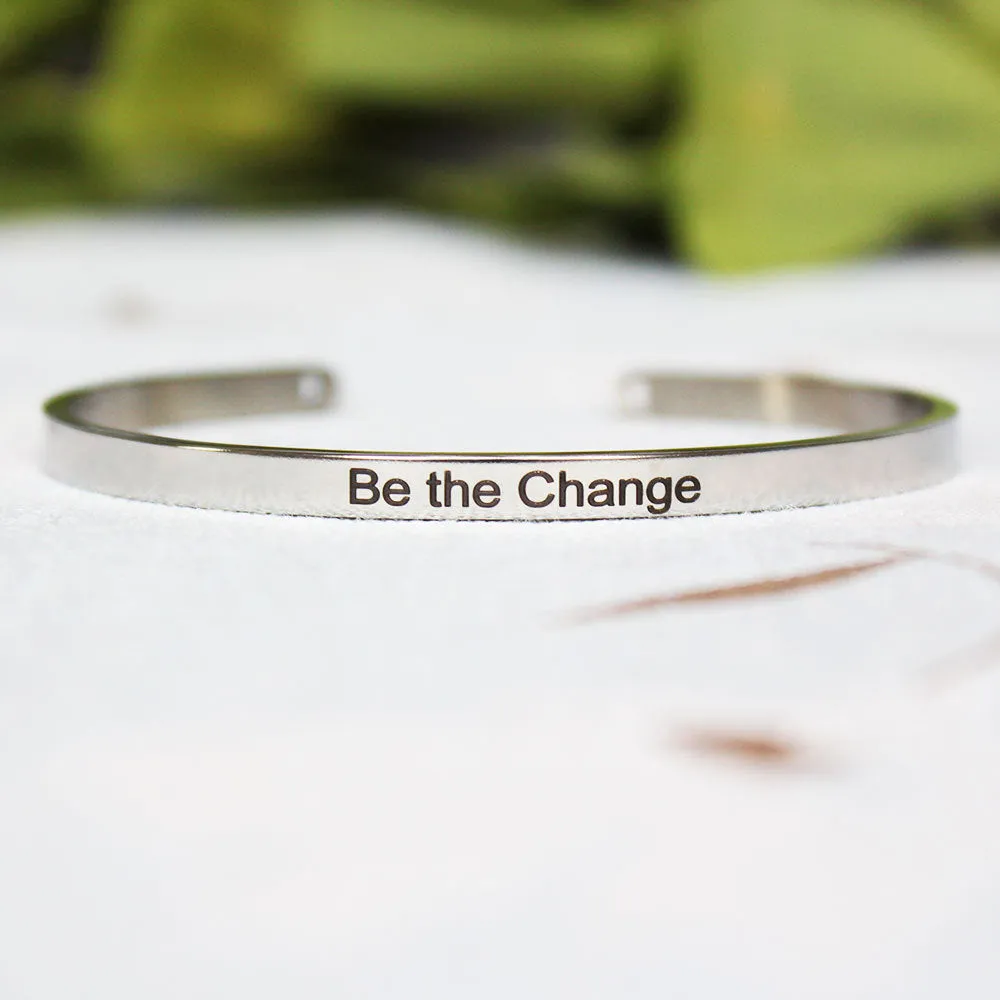 Silver customisable stainless steel bracelet with laser engraved text and adjustable fit on neutral background