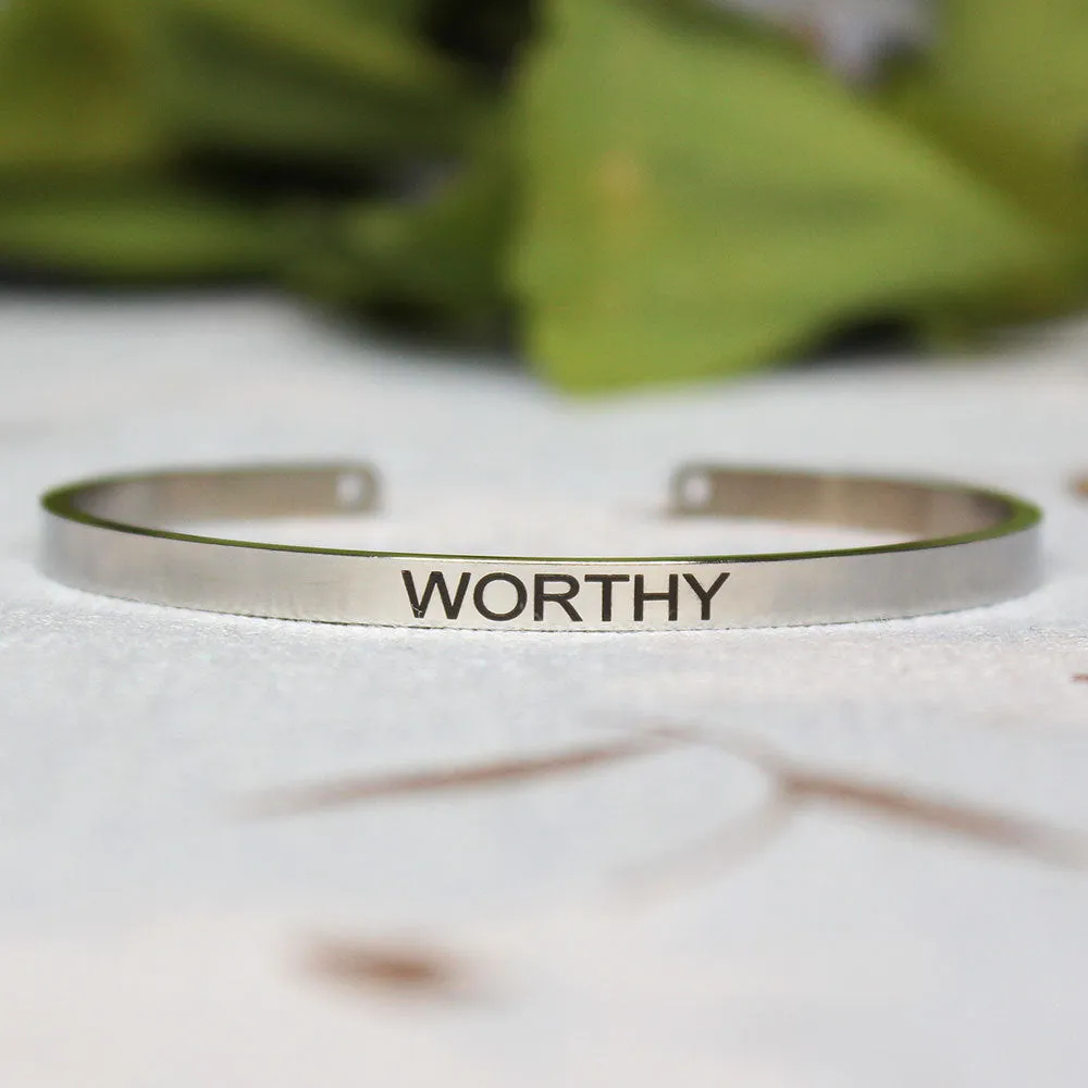 Silver customisable stainless steel bracelet with laser engraved text and adjustable fit on neutral background