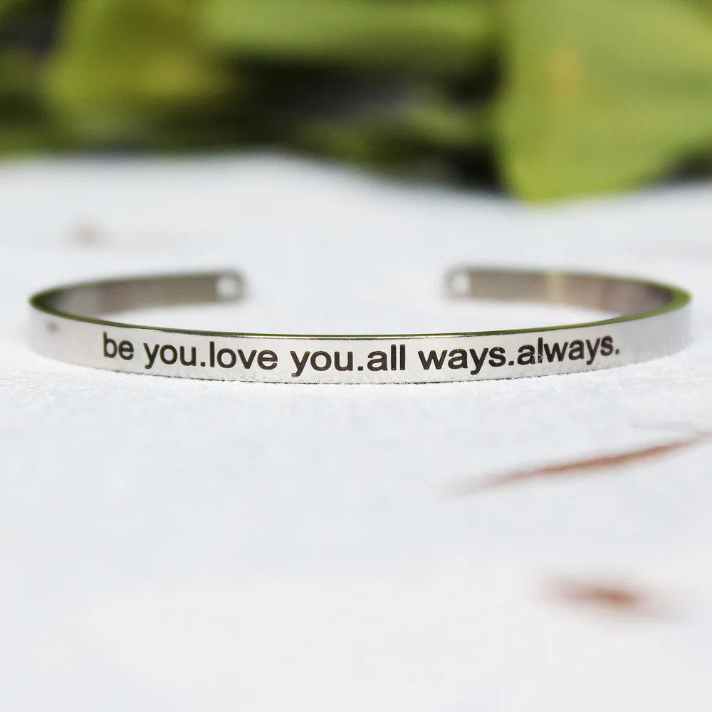 Silver customisable stainless steel bracelet with laser engraved text and adjustable fit on neutral background