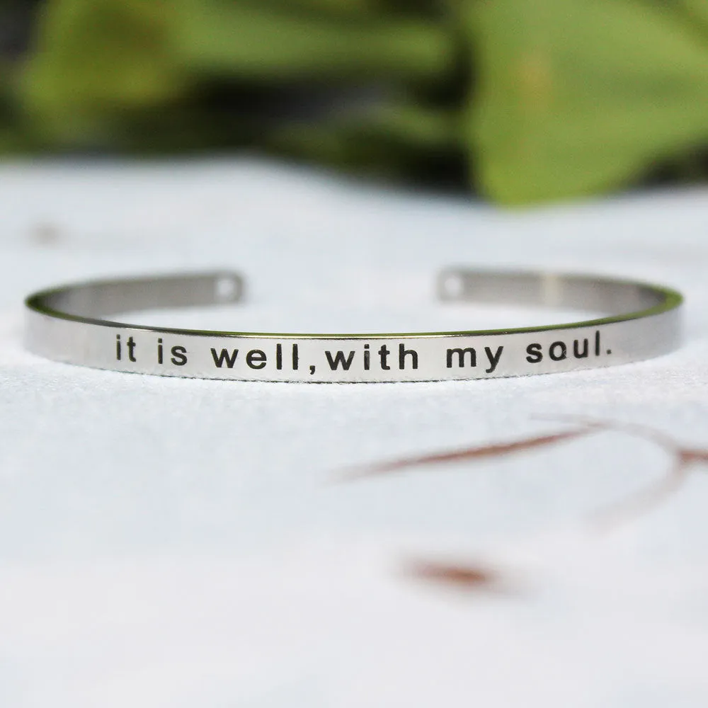 Silver customisable stainless steel bracelet with laser engraved text and adjustable fit on neutral background