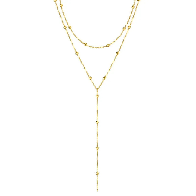 Fashion long necklace with geometric tassel and round beads in gold colour on clavicle chain