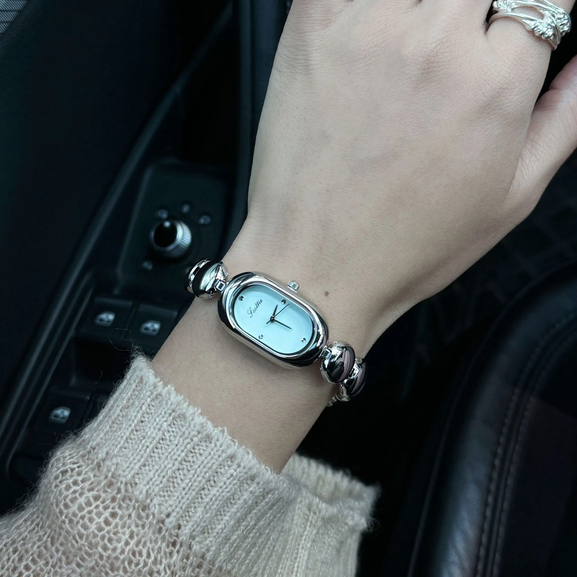 Women's oval gold tone watch with bracelet and 9mm case thickness