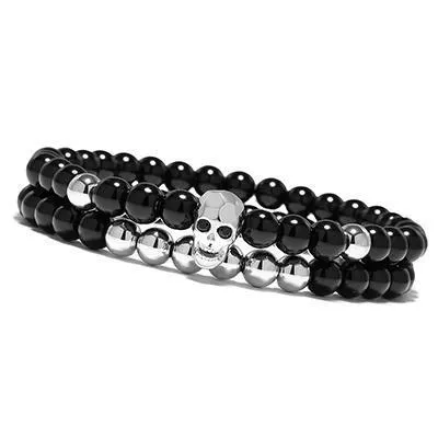 Metal smile skull bracelet in Black finish on a flat surface