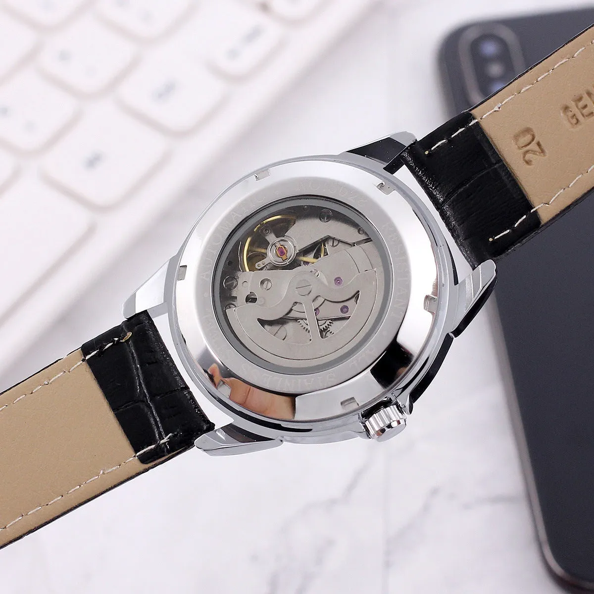 Men's transparent skeleton quartz watch with genuine leather strap on wrist, 37mm dial, alloy case, and stainless steel buckle