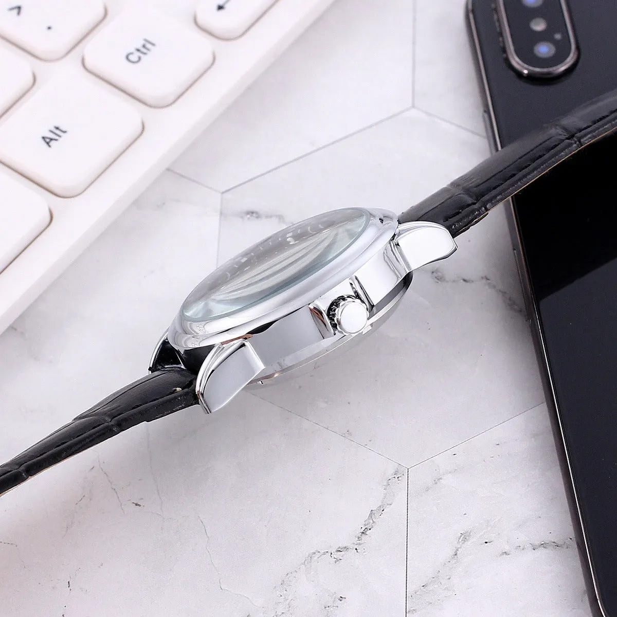 Men's transparent skeleton quartz watch with genuine leather strap on wrist, 37mm dial, alloy case, and stainless steel buckle
