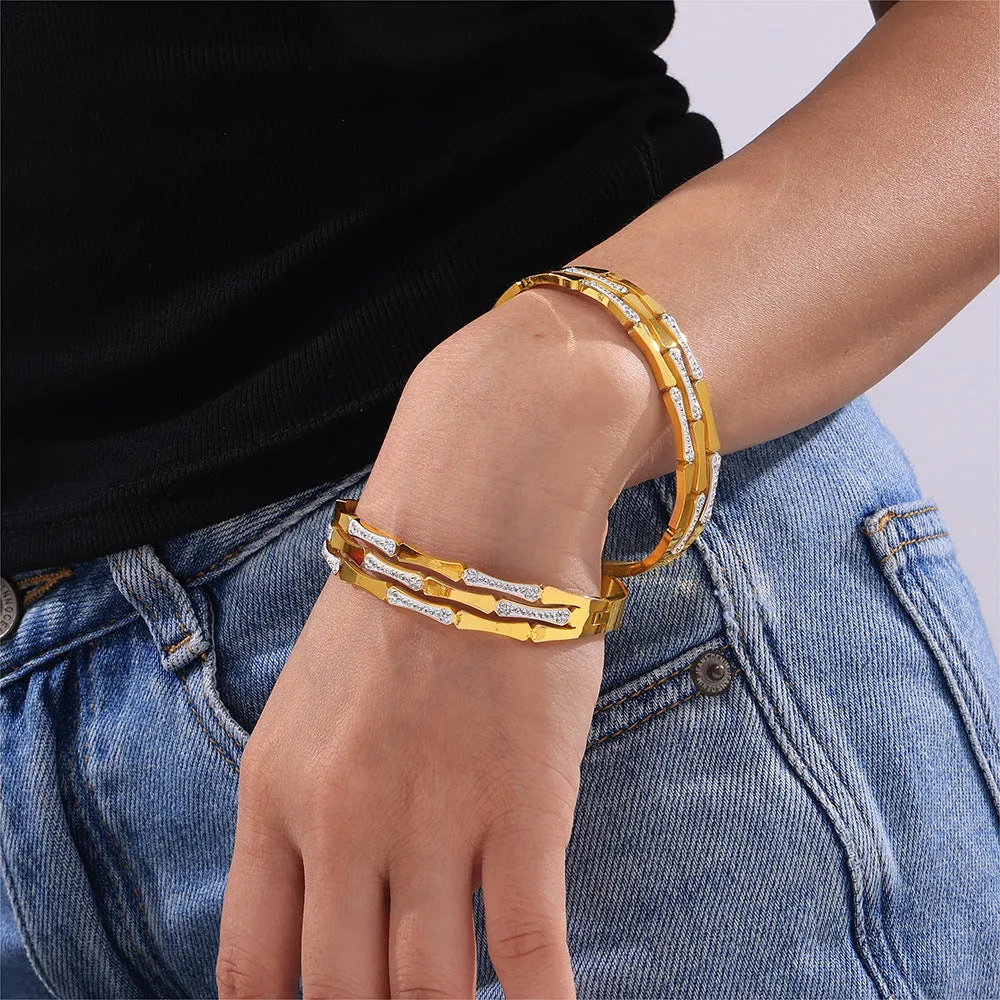 Gold electroplated titanium steel hollow splicing casual bracelet for women, open cuff design on white background