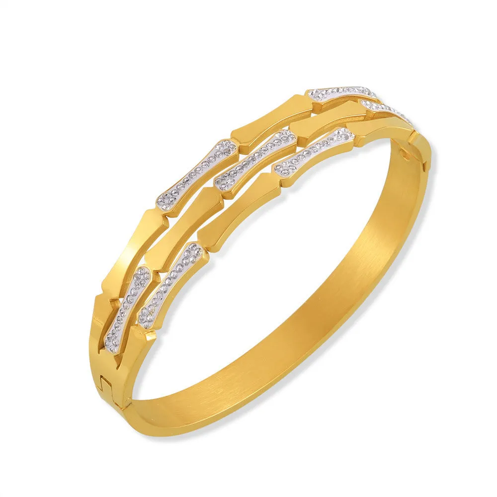 Gold electroplated titanium steel hollow splicing casual bracelet for women, open cuff design on white background