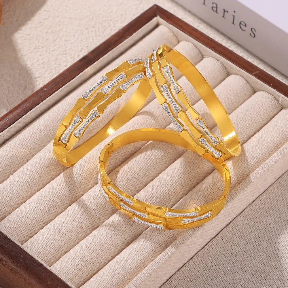 Gold electroplated titanium steel hollow splicing casual bracelet for women, open cuff design on white background