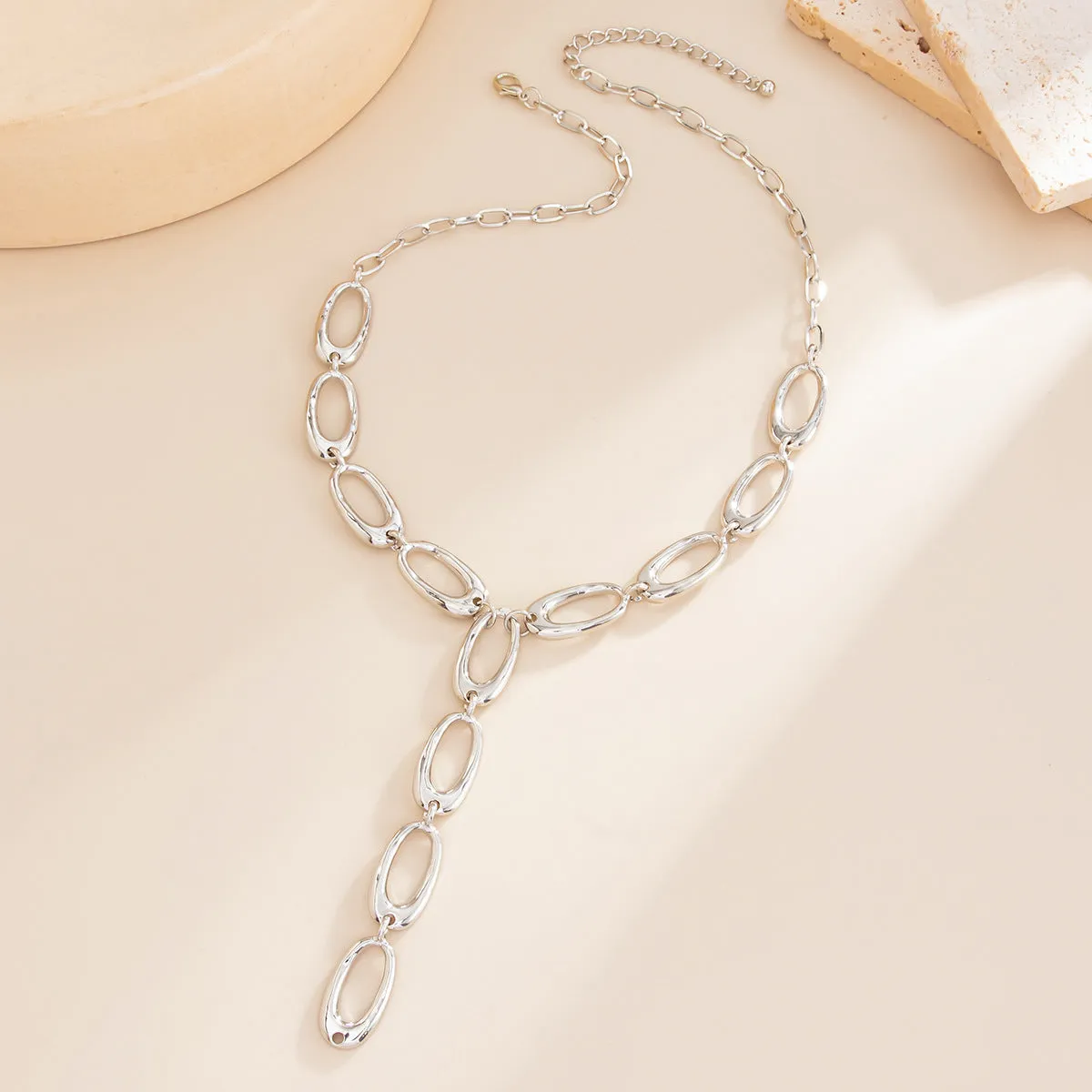 Metal textured Y-shaped cross necklace with alloy chain in gold finish on white background