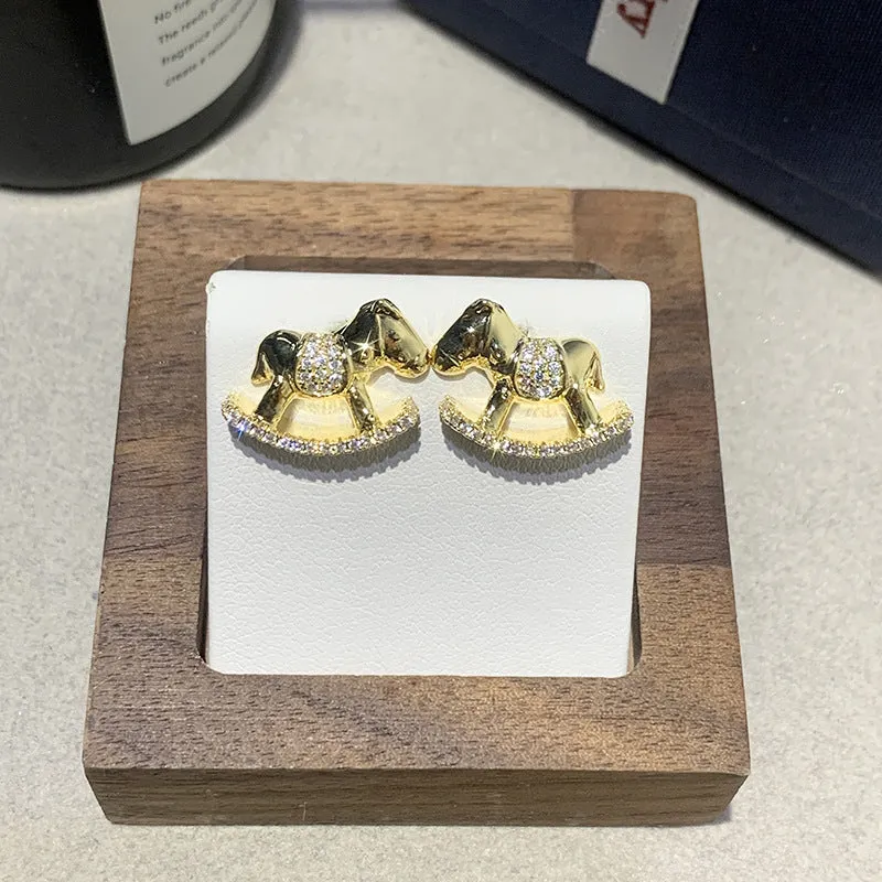 Diamond studded women's light luxury rocking horse drop earrings in gold colour on display