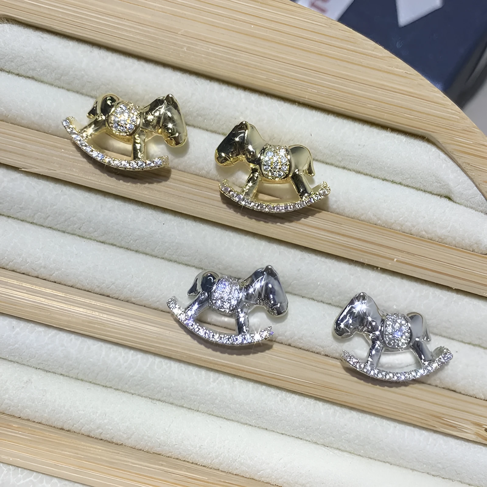 Diamond studded women's light luxury rocking horse drop earrings in gold colour on display
