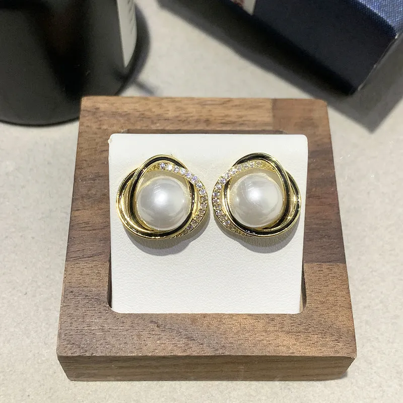 Set of three fashionable versatile earrings in silver gold and rose gold finishes on a light background