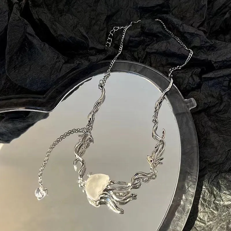 Alloy jellyfish tassel necklace and earring set in electroplated white finish on display