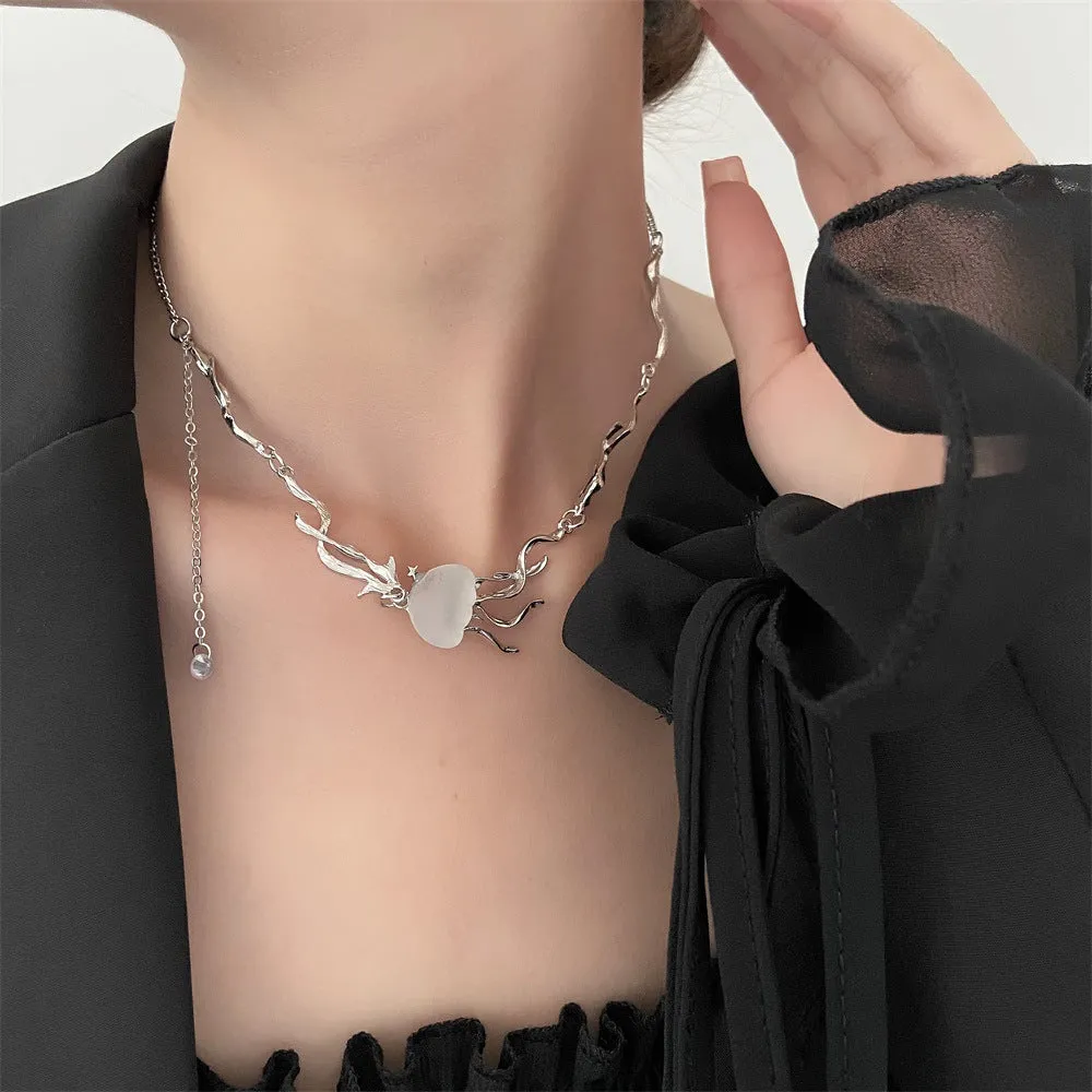 Alloy jellyfish tassel necklace and earring set in electroplated white finish on display