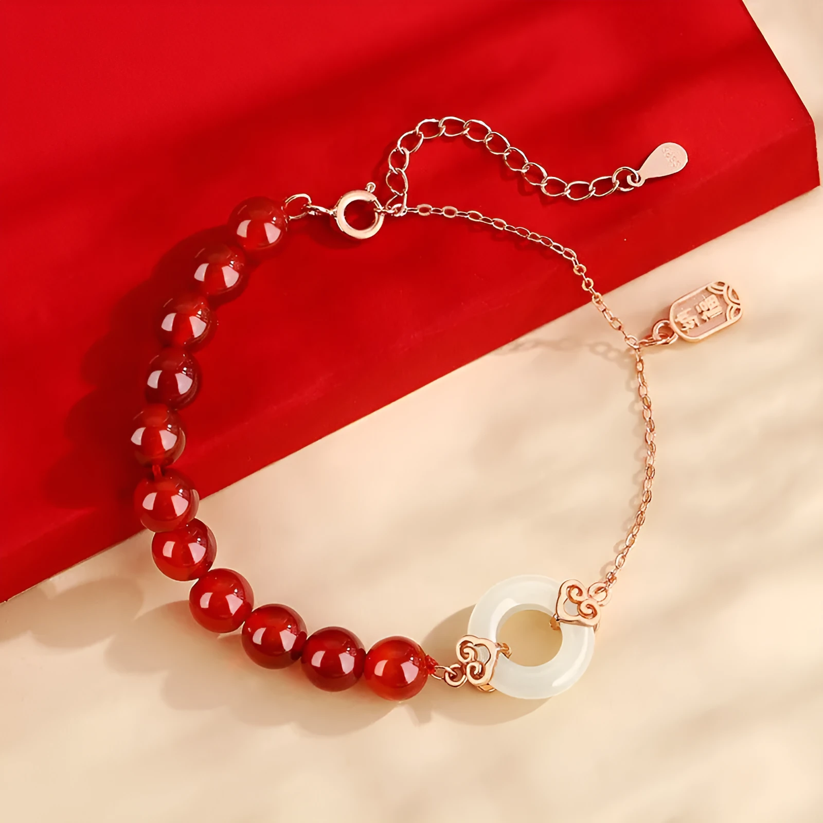 Close-up of a women's sterling silver bracelet with a peace buckle, xiangyun cloud patterns, and a Fu character.