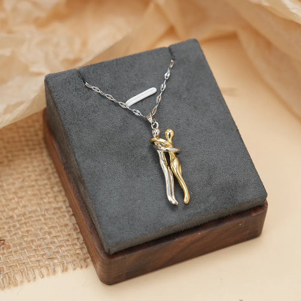 Couple hugging bronze pendant necklace on unisex stainless steel chain with gold lip chain finish, casual style