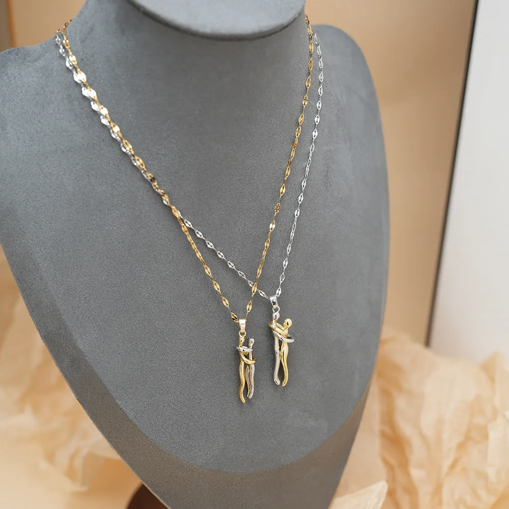 Couple hugging bronze pendant necklace on unisex stainless steel chain with gold lip chain finish, casual style