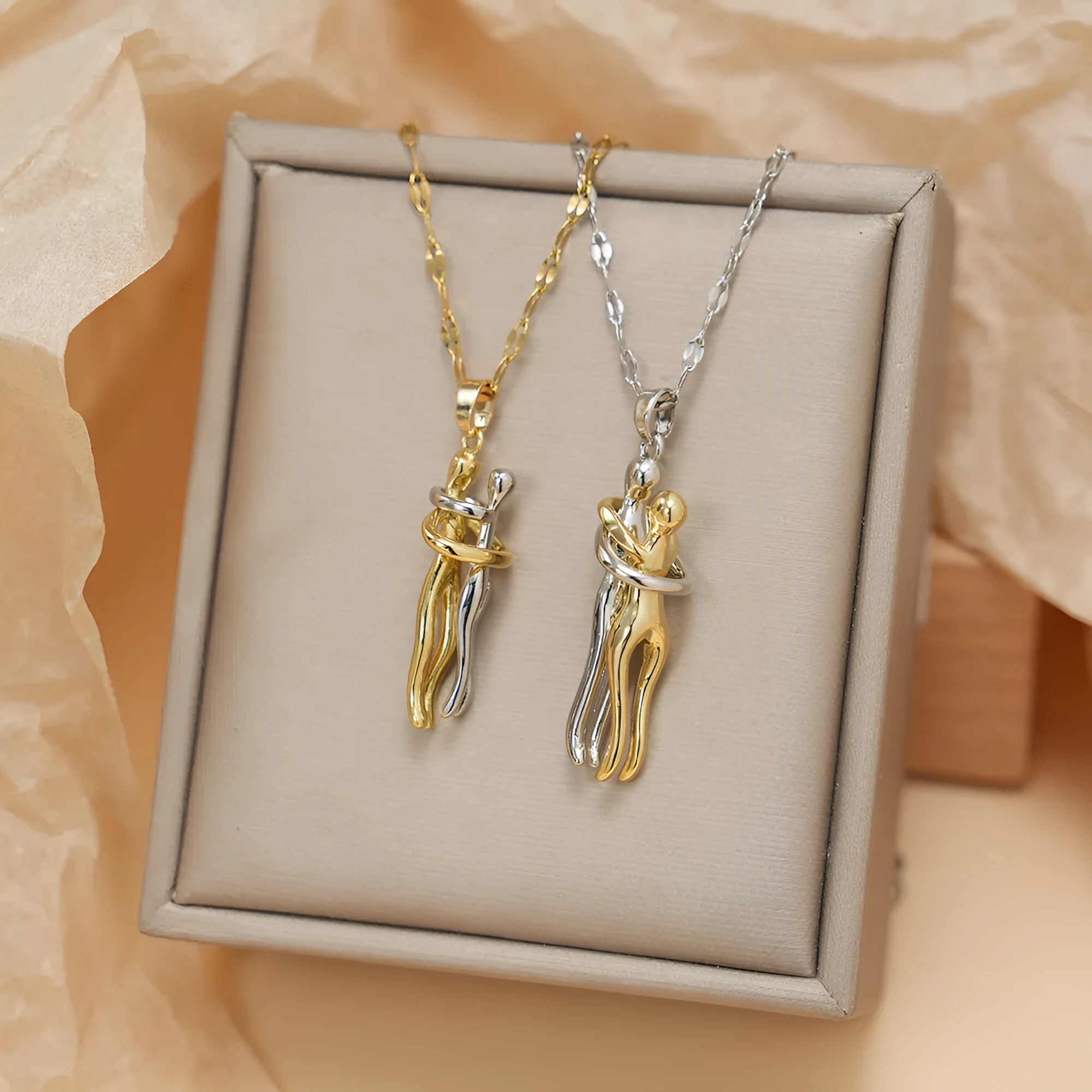 Couple hugging bronze pendant necklace on unisex stainless steel chain with gold lip chain finish, casual style