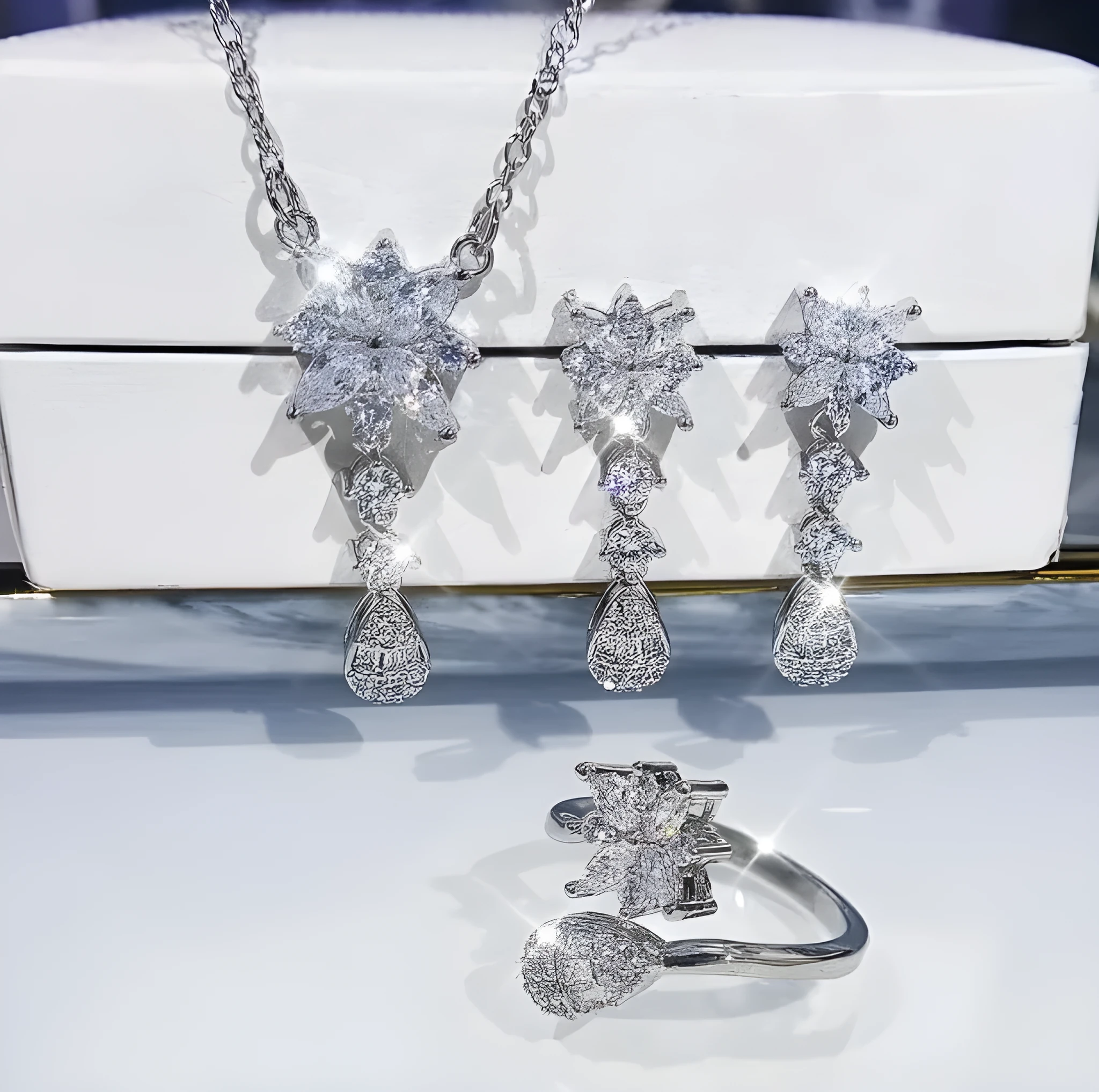 Floral zircon bridal jewellery set including ring, necklace with curb chain, and earrings on brass
