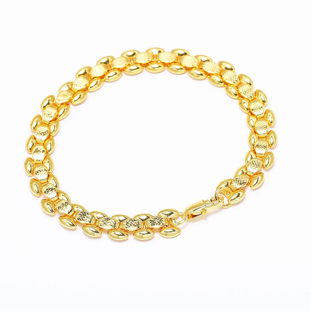 L254 Gold iron bracelet laid flat on a surface, showing its metallic finish and simple design.