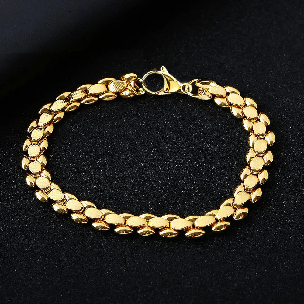 L254 Gold iron bracelet laid flat on a surface, showing its metallic finish and simple design.