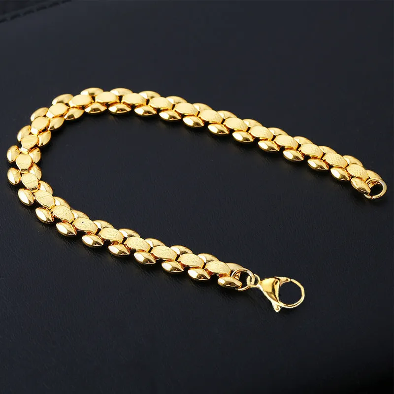 L254 Gold iron bracelet laid flat on a surface, showing its metallic finish and simple design.