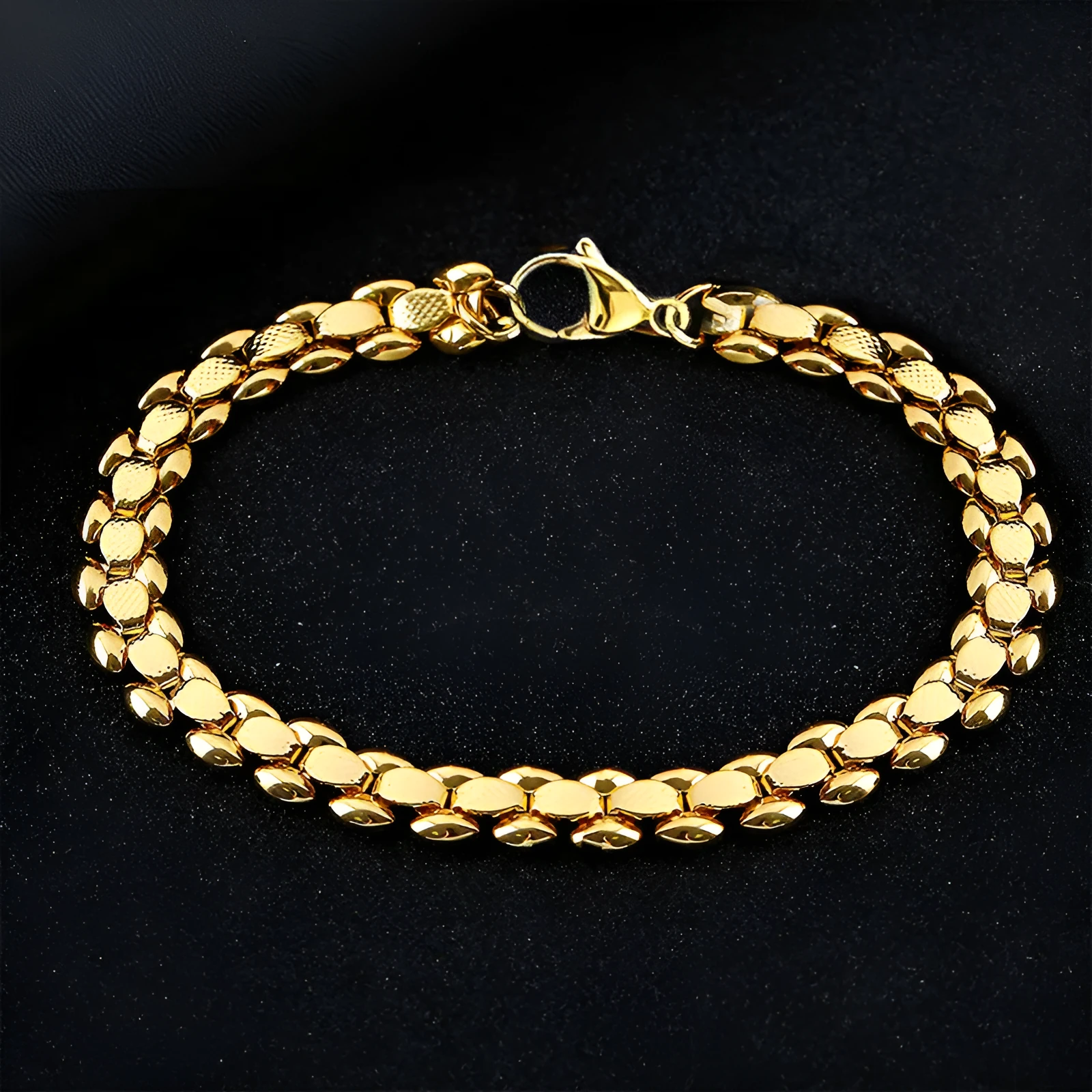 L254 Gold iron bracelet laid flat on a surface, showing its metallic finish and simple design.