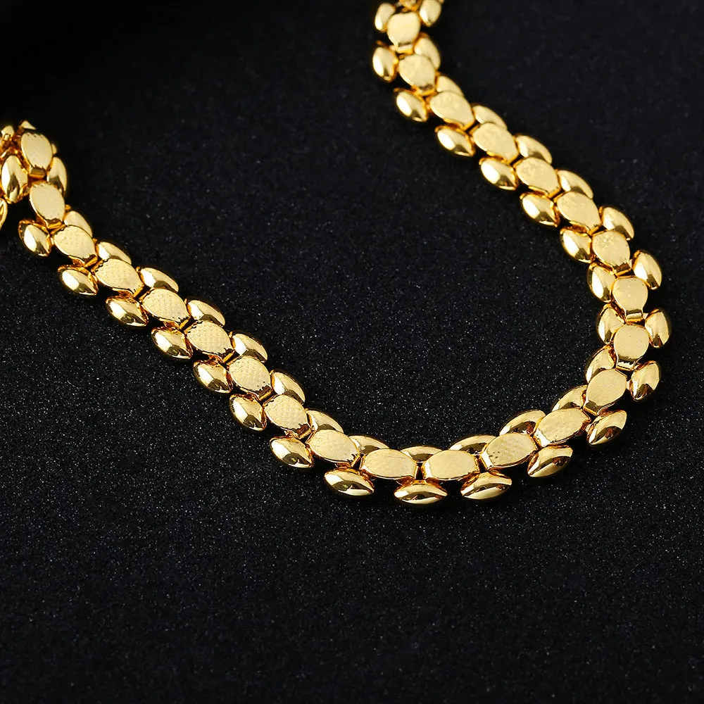 L254 Gold iron bracelet laid flat on a surface, showing its metallic finish and simple design.