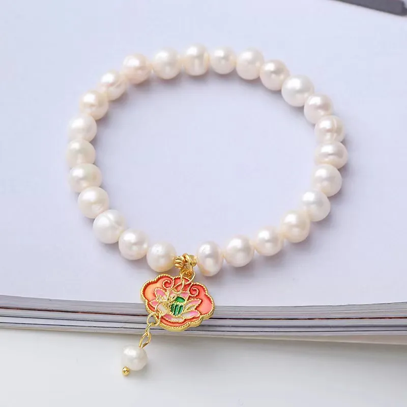 White vintage baroque bracelet with a freshwater pearl and goldfish lotus pendant.