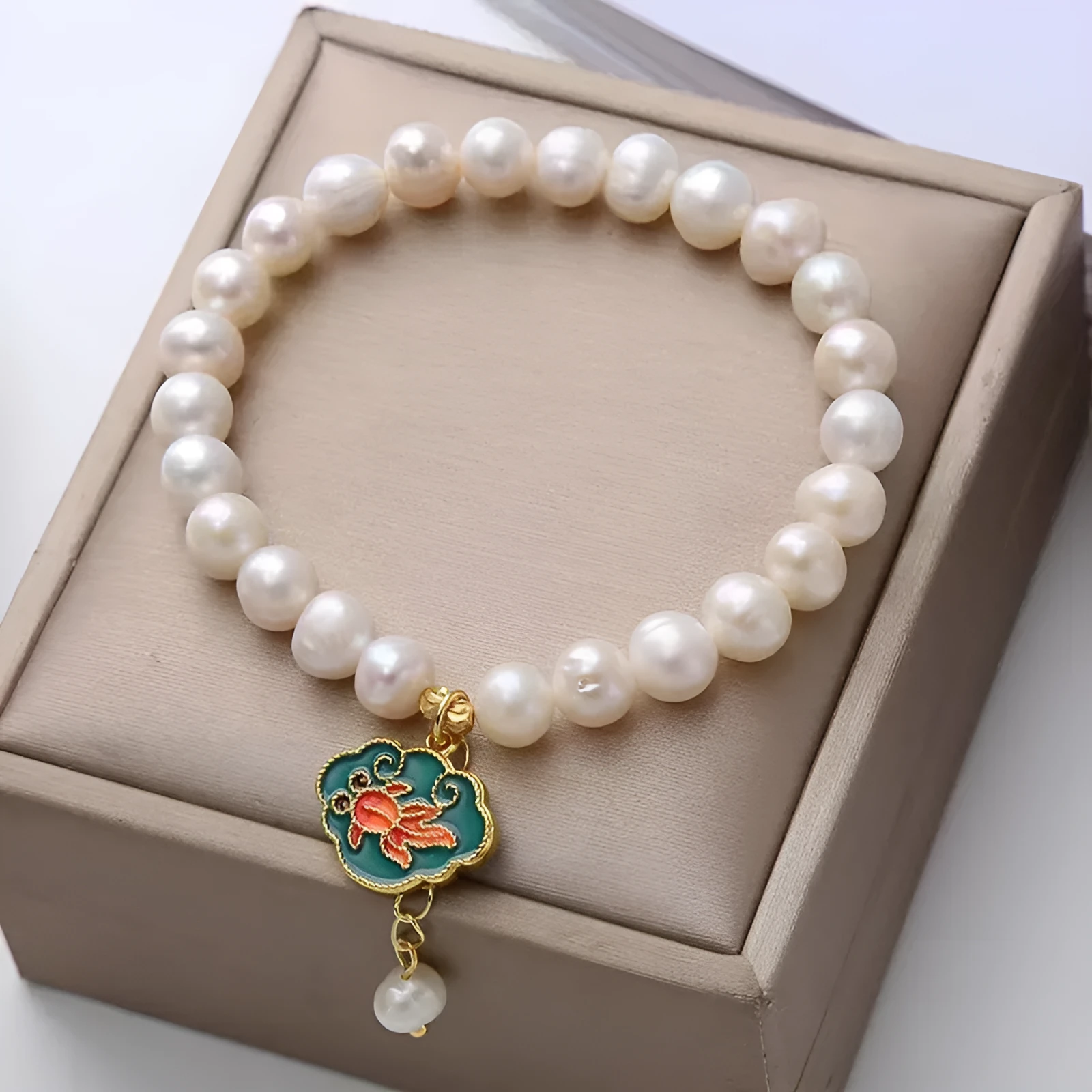 White vintage baroque bracelet with a freshwater pearl and goldfish lotus pendant.