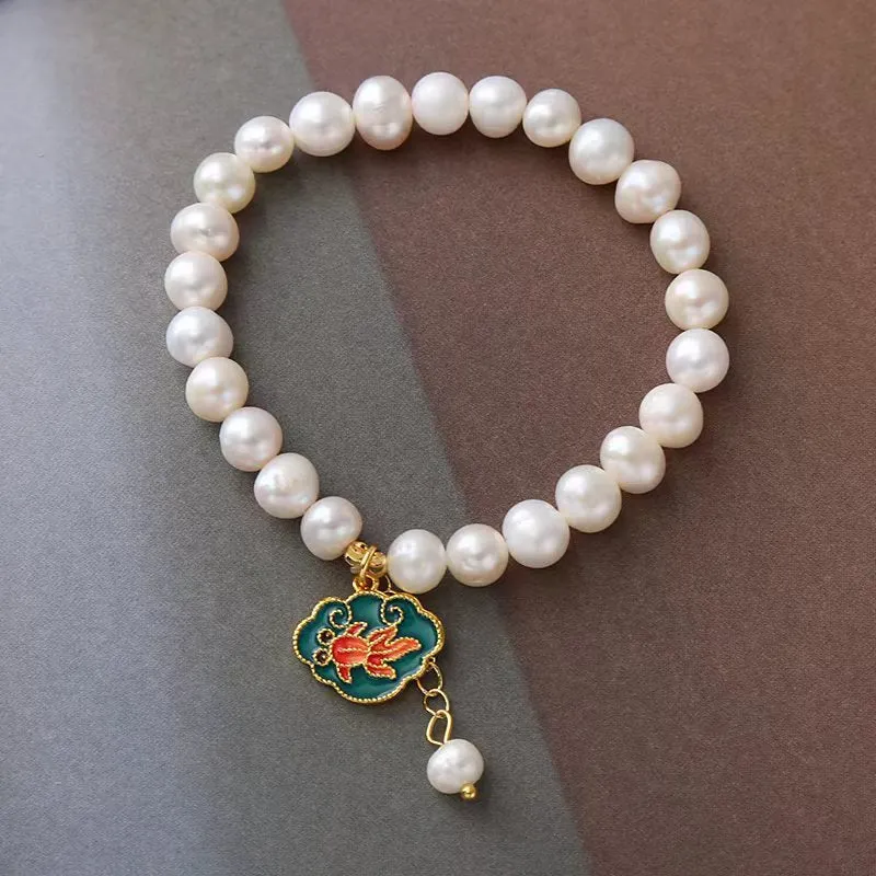 White vintage baroque bracelet with a freshwater pearl and goldfish lotus pendant.