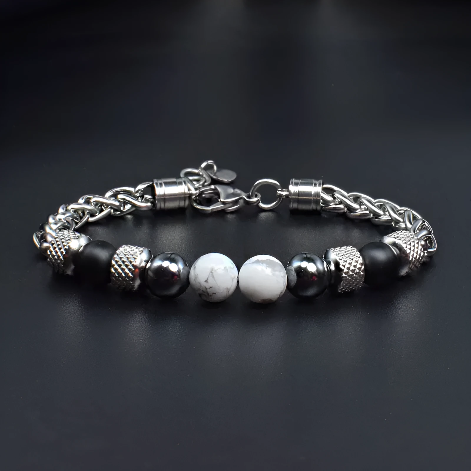 Titanium steel polished bracelet with yellow tiger eye beads and iron accents on white background