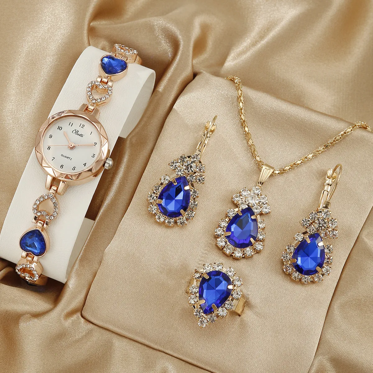 Women's simple disc light luxury quartz bracelet watch set in pink with matching earrings necklace and ring