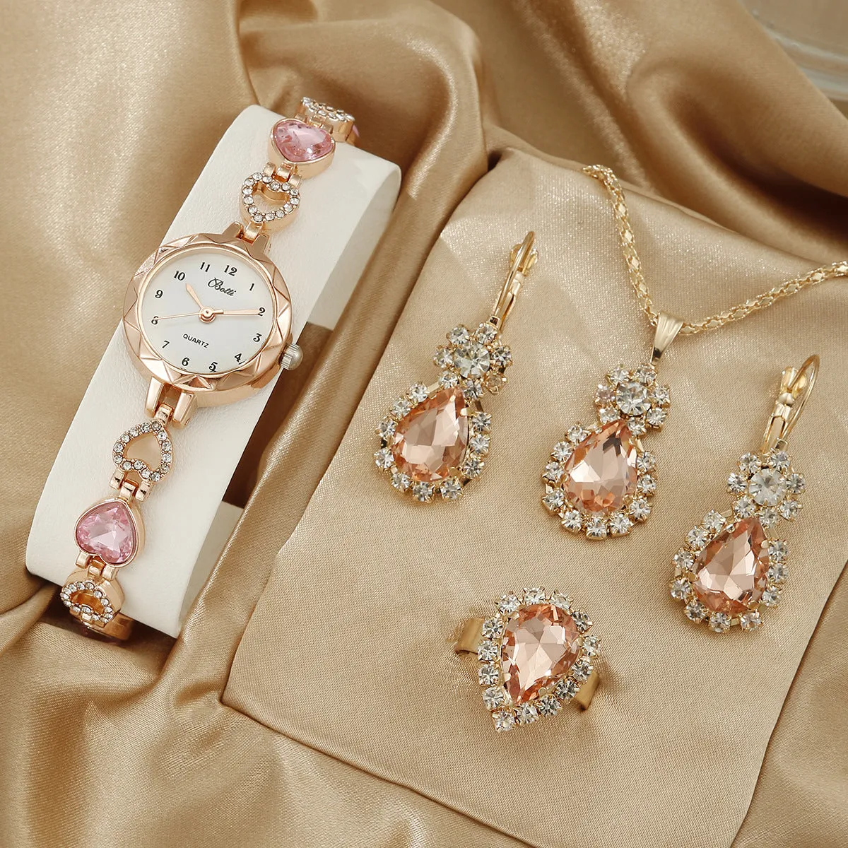 Women's simple disc light luxury quartz bracelet watch set in pink with matching earrings necklace and ring