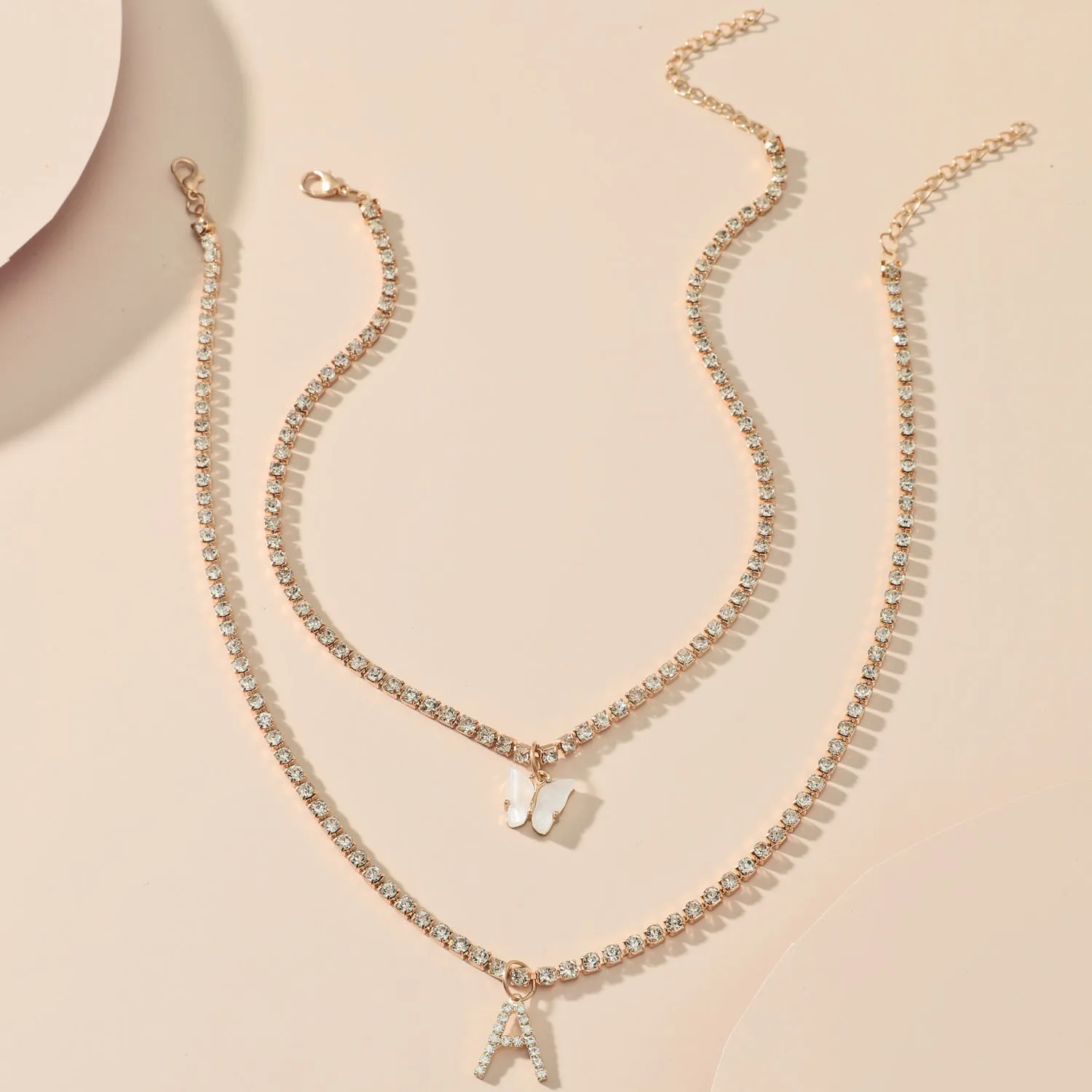 Personalised diamond letter necklace with rhinestone pendant on claw chain in gold finish