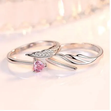 Silver adjustable heart diamond ring with geometric design on a plain background