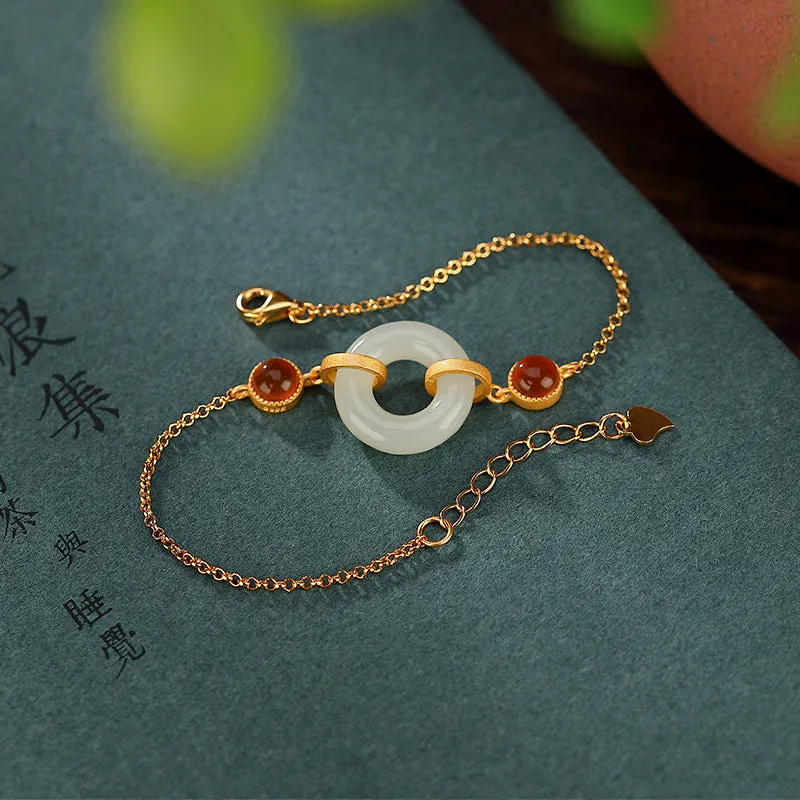 Gold-coloured women's bracelet with a silver base and an inlaid Hetian jade peace buckle charm.