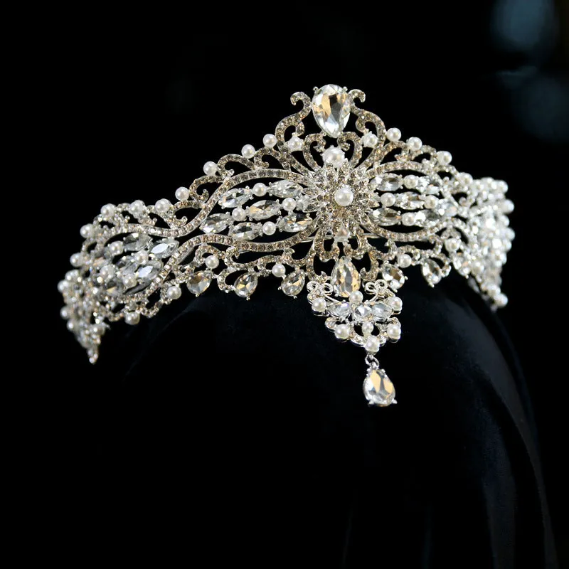 Silver alloy baroque bride crown with pearl and quota decoration on a white background