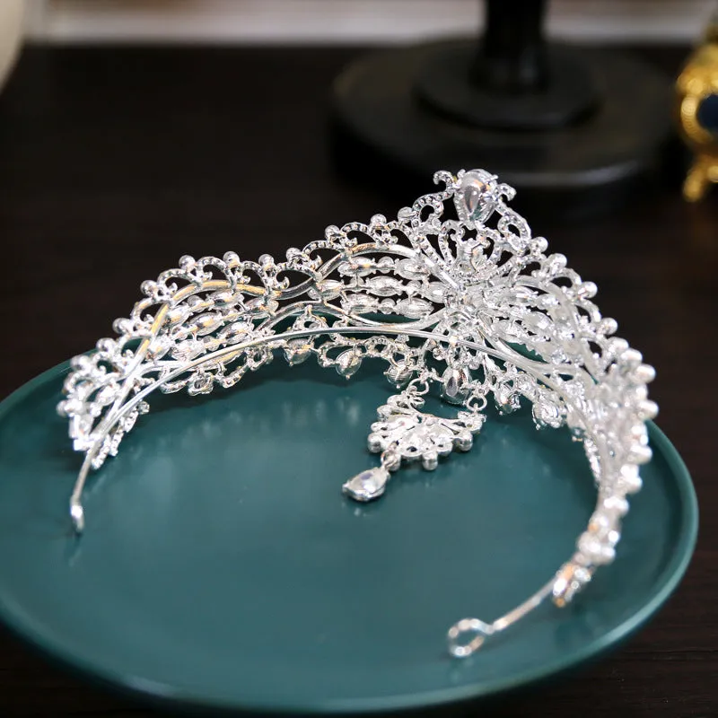 Silver alloy baroque bride crown with pearl and quota decoration on a white background