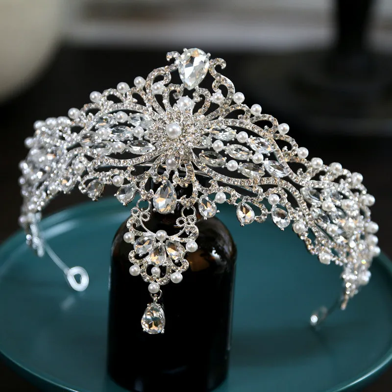 Silver alloy baroque bride crown with pearl and quota decoration on a white background