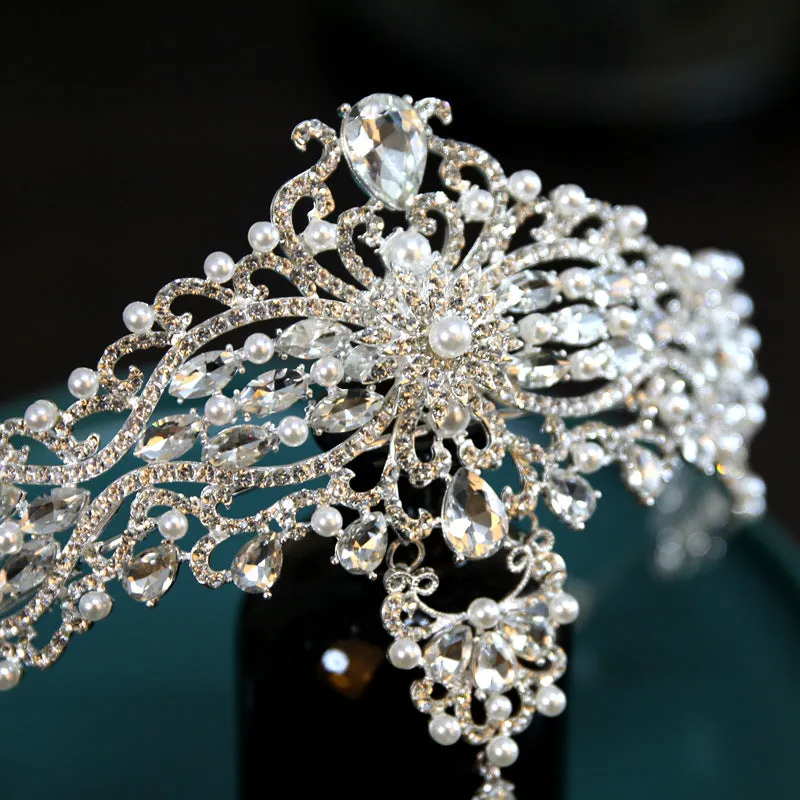Silver alloy baroque bride crown with pearl and quota decoration on a white background