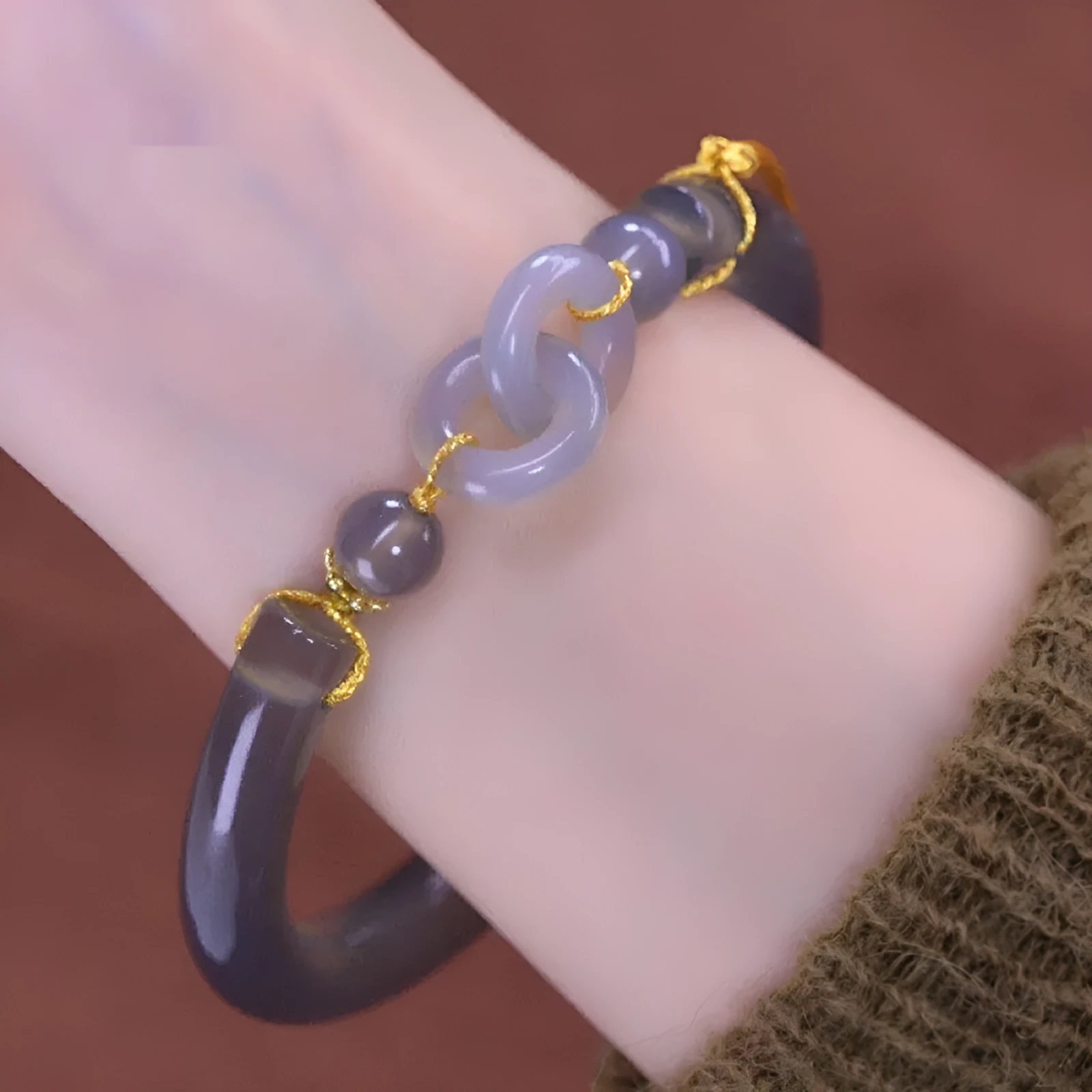 Grey smoke purple agate bead bracelet with metal ring buckle closure on a wrist.