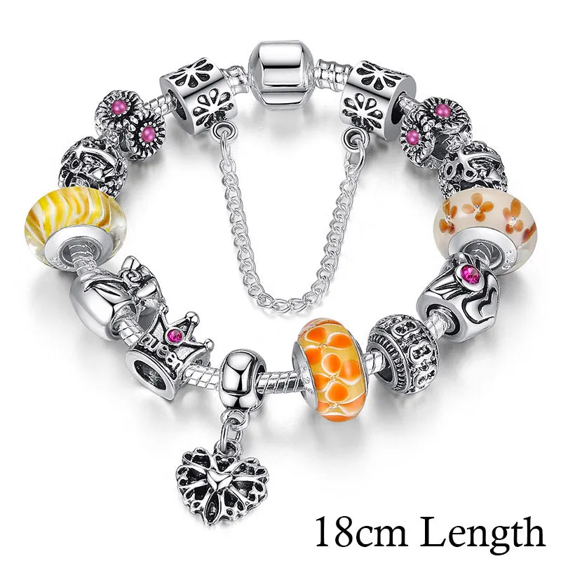 Silver plated alloy bracelet with queen crown beads and pink Murano glass beads for women on white background