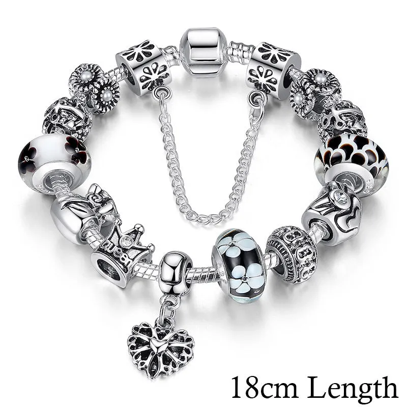Silver plated alloy bracelet with queen crown beads and pink Murano glass beads for women on white background