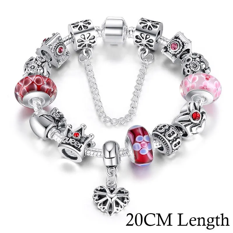 Silver plated alloy bracelet with queen crown beads and pink Murano glass beads for women on white background