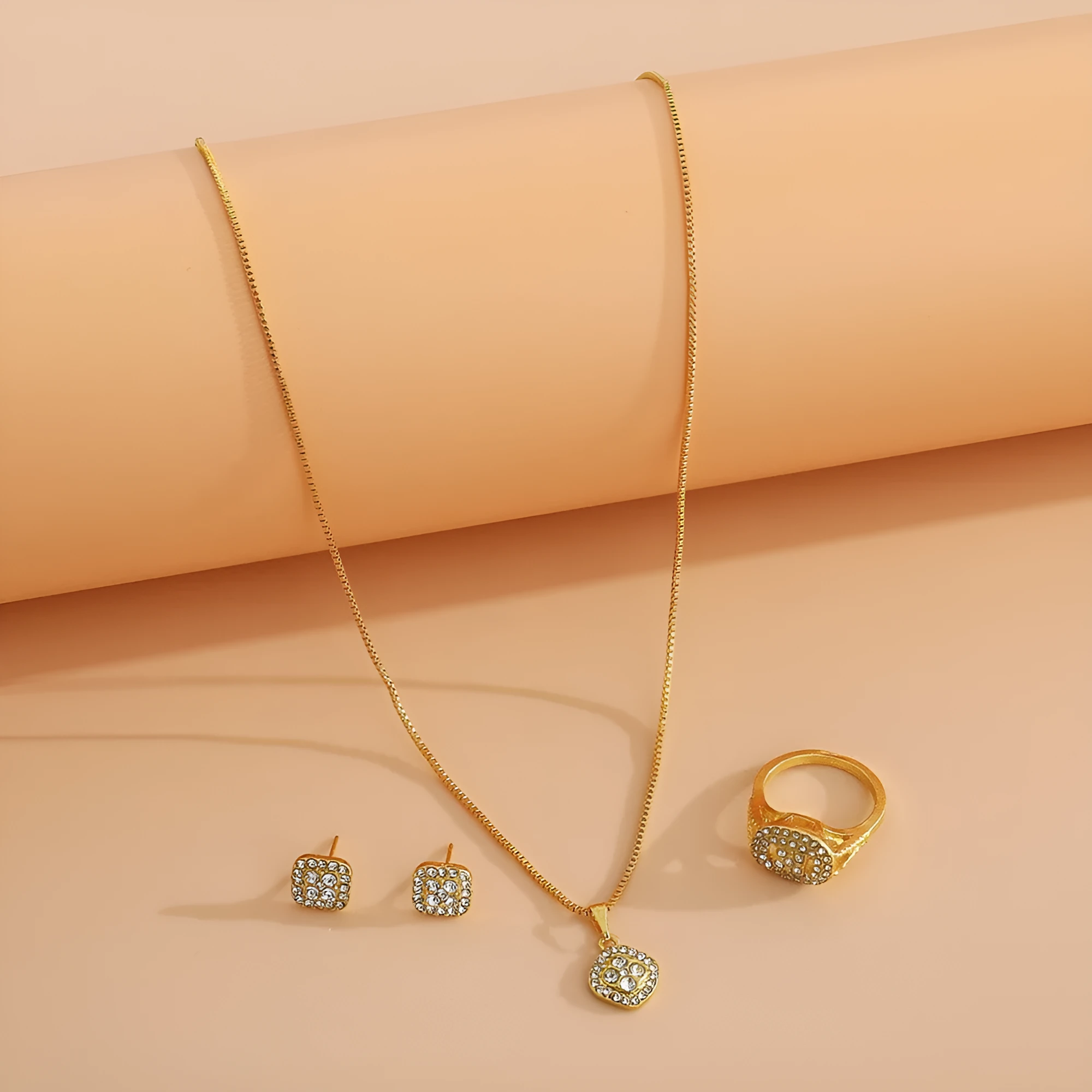 Three-piece alloy rhinestone wedding jewellery set with ring, stud earrings, and necklace in gold finish