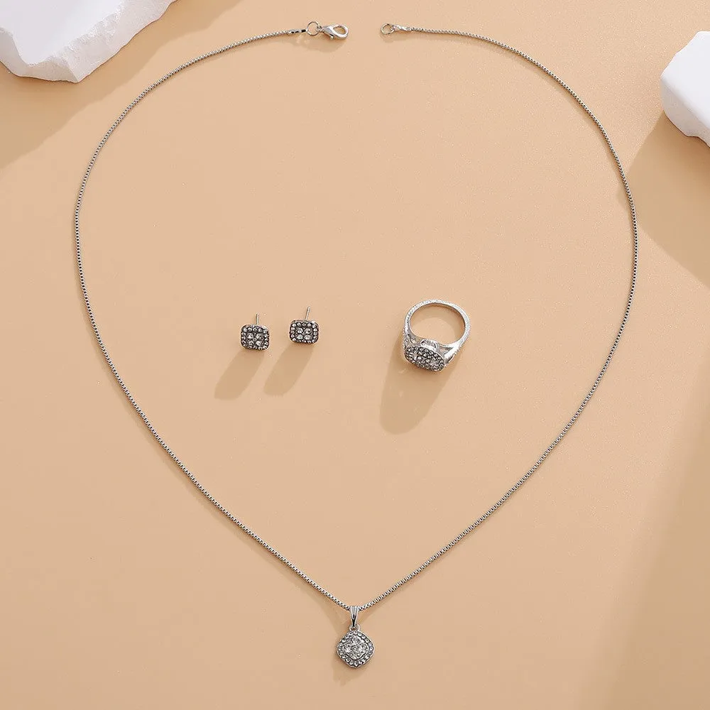 Three-piece alloy rhinestone wedding jewellery set with ring, stud earrings, and necklace in gold finish