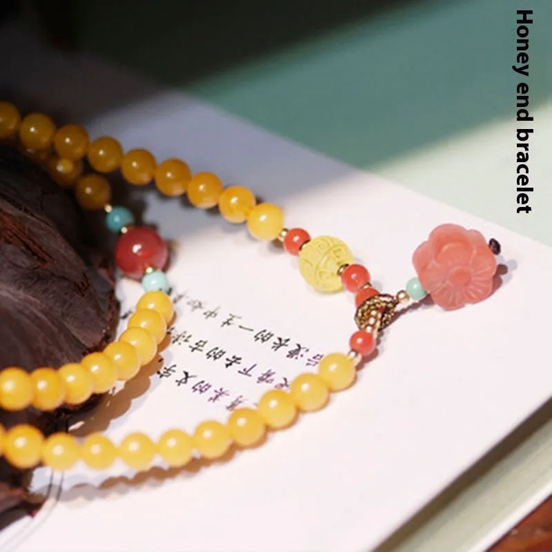 Yellow chicken grease beeswax design on 5mm amber bracelet with animal zodiac modelling