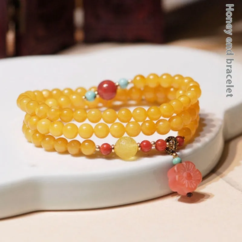 Yellow chicken grease beeswax design on 5mm amber bracelet with animal zodiac modelling